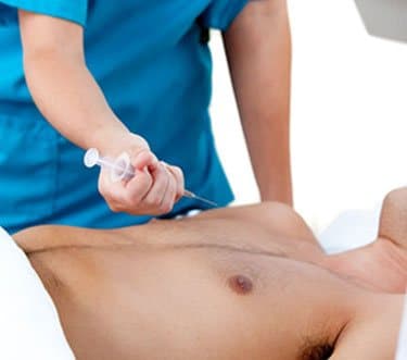 surgeon injecting anesthetics in male breast