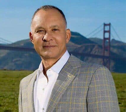 Dr. Delgado in a field by the golden gate bridge